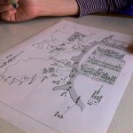 船に乗って、瀬戸内の島々を繋ぐ航路図を広げてます。